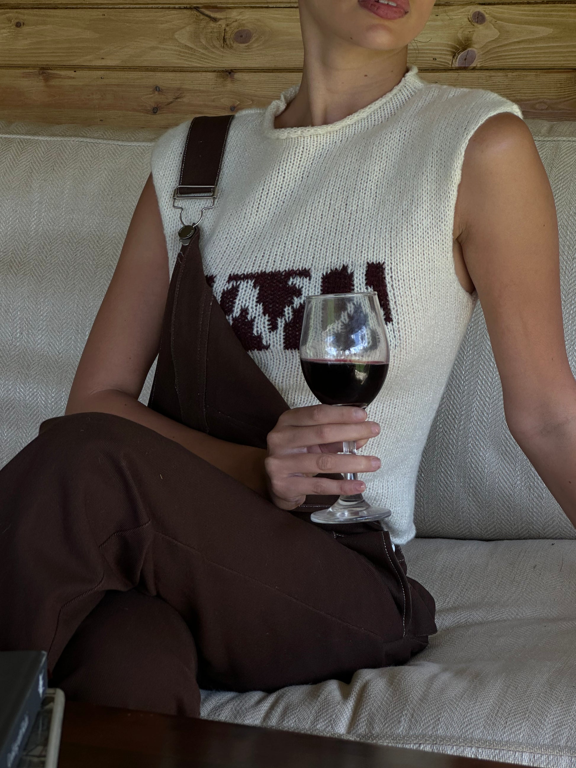 Woman wearing cream knitted top with brown print in countryside 